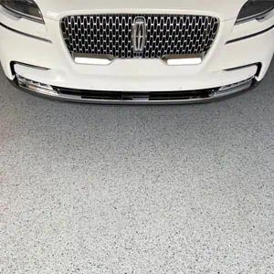 White Lincoln parked on an epoxy garage floor.